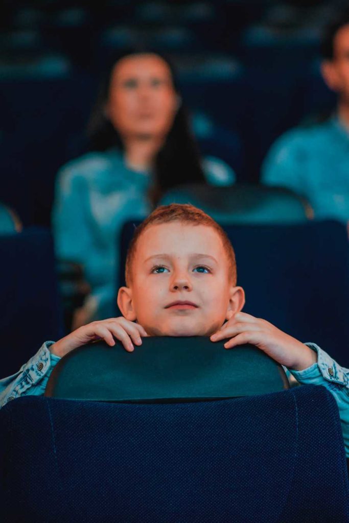 Enfant émerveillé devant un film au cinéma